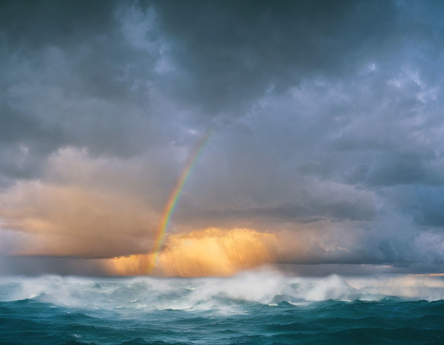 Stormy Sea with Dark Clouds and Bright Rainbow Over Choppy Waves