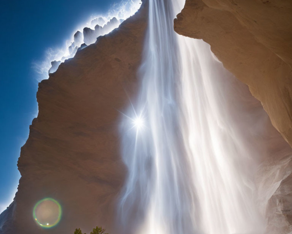 Sunbeams through waterfall over rocky overhang: light and shadow play in nature