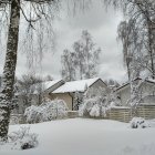 Snow-covered village with golden light and falling snowflakes