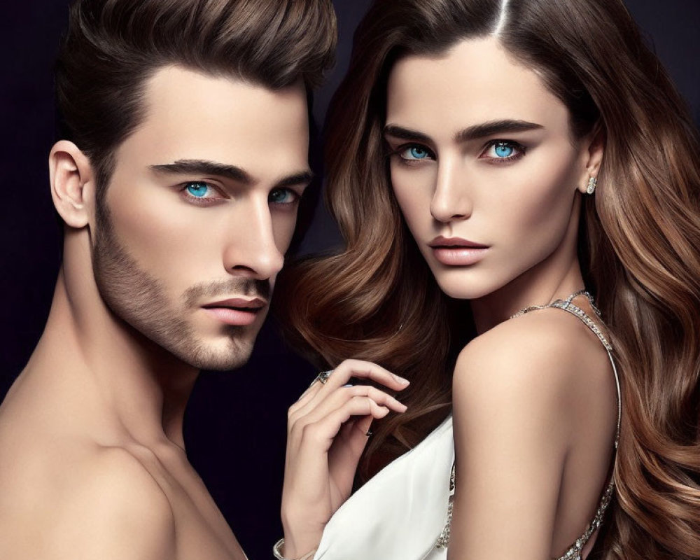 Striking blue-eyed man and woman in elegant pose against dark background