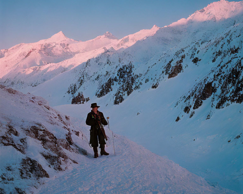 Person in Traditional Attire on Snowy Mountain Path at Dawn or Dusk