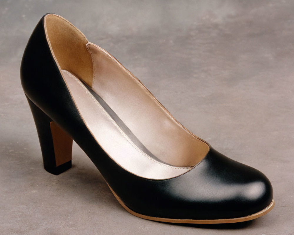 Black High-Heeled Shoe with Round Toe and Brown Heel on Gray Background