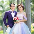 Wedding couple in forest setting, embracing and smiling