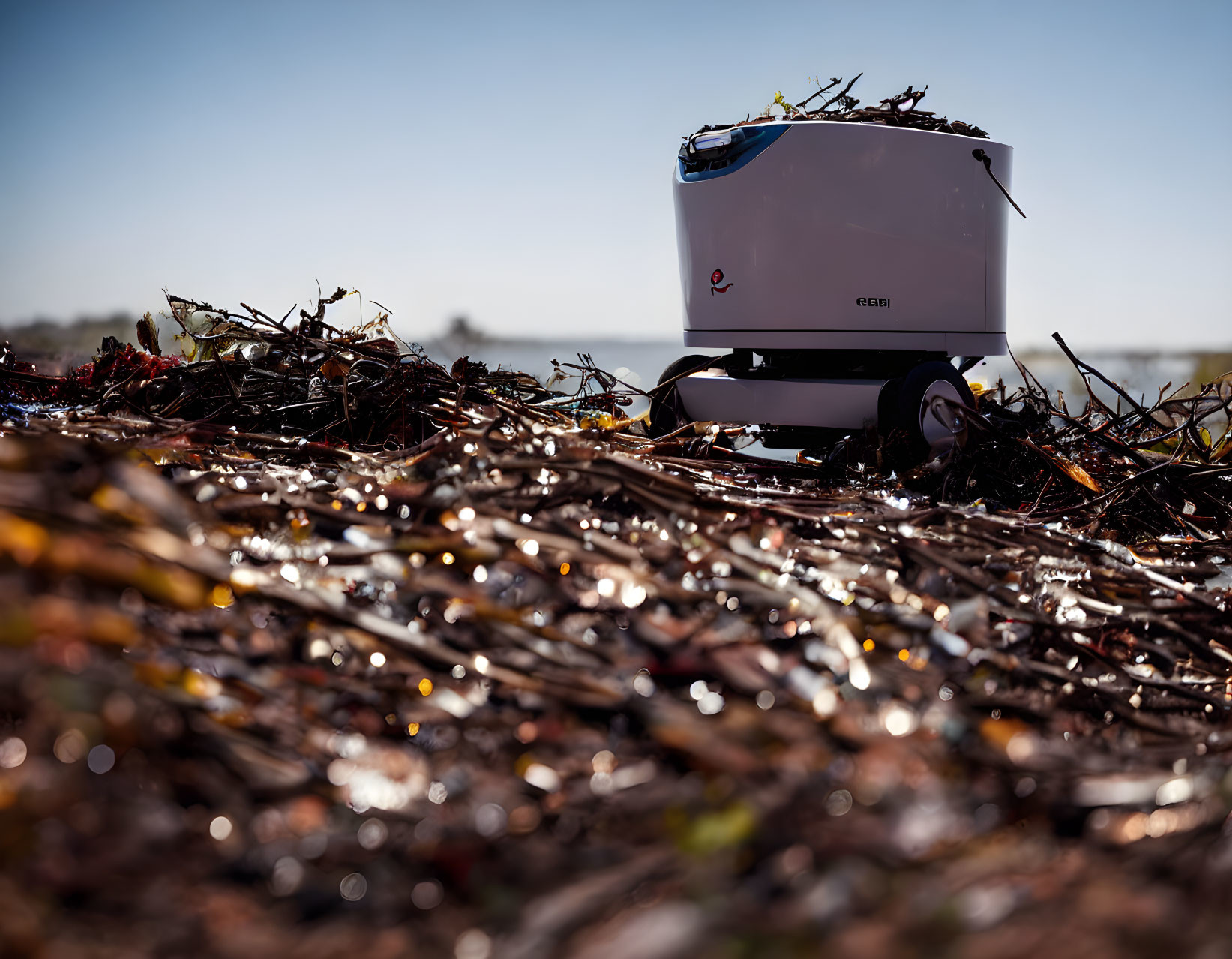 Autonomous Agricultural Robot in White and Red Amid Field Debris