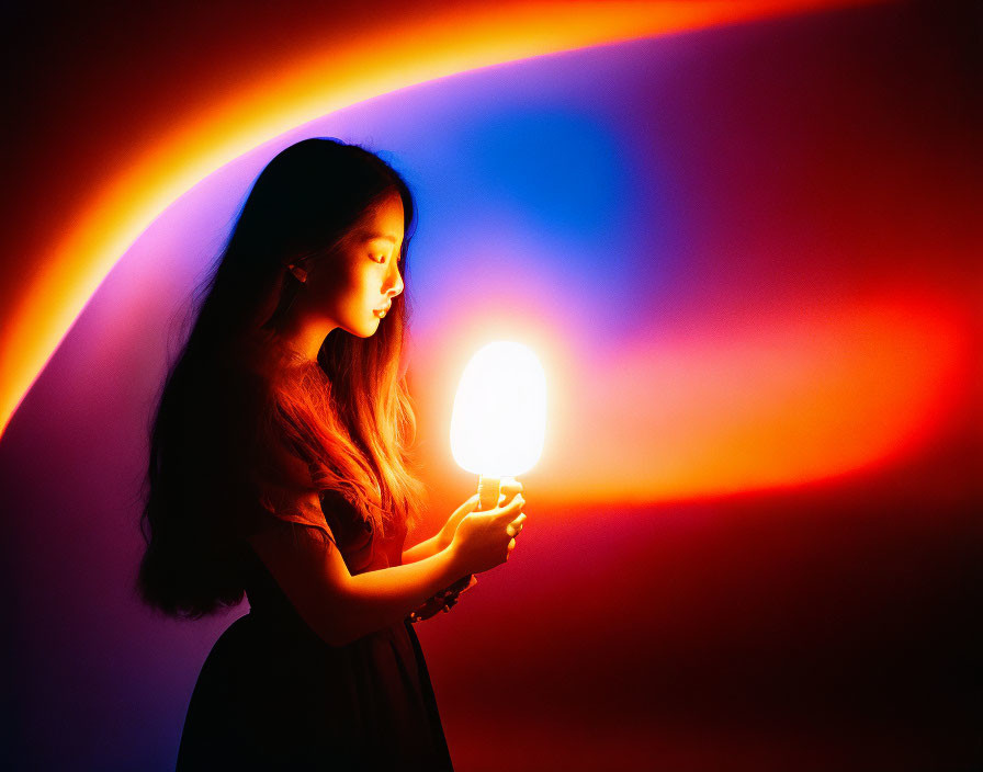 Girl with Flowing Hair Holding Glowing Object in Colorful Background