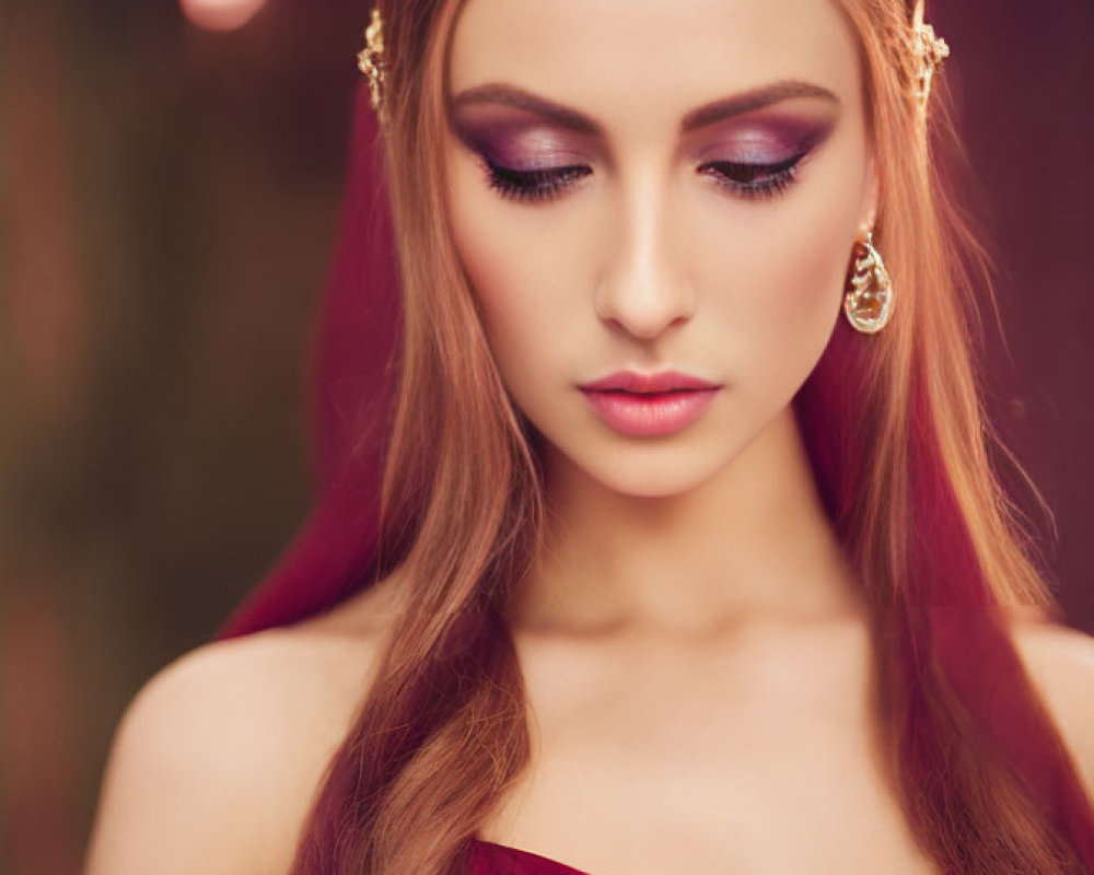 Regal woman in crown and burgundy gown with striking makeup