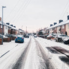 Winter scene: Snowy village street with traditional houses and decorative lamps