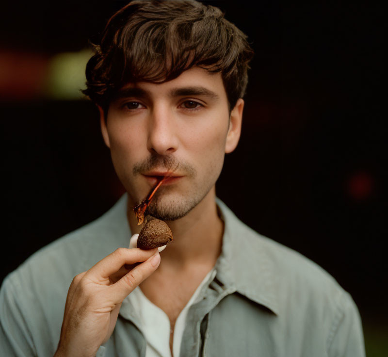 Man with Short Hair Smoking Pipe in Blurred Background