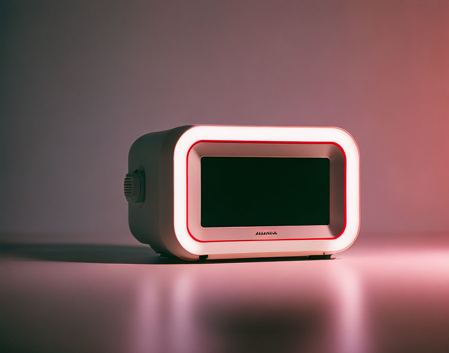 Box-shaped projector with glowing red outline on pink gradient background