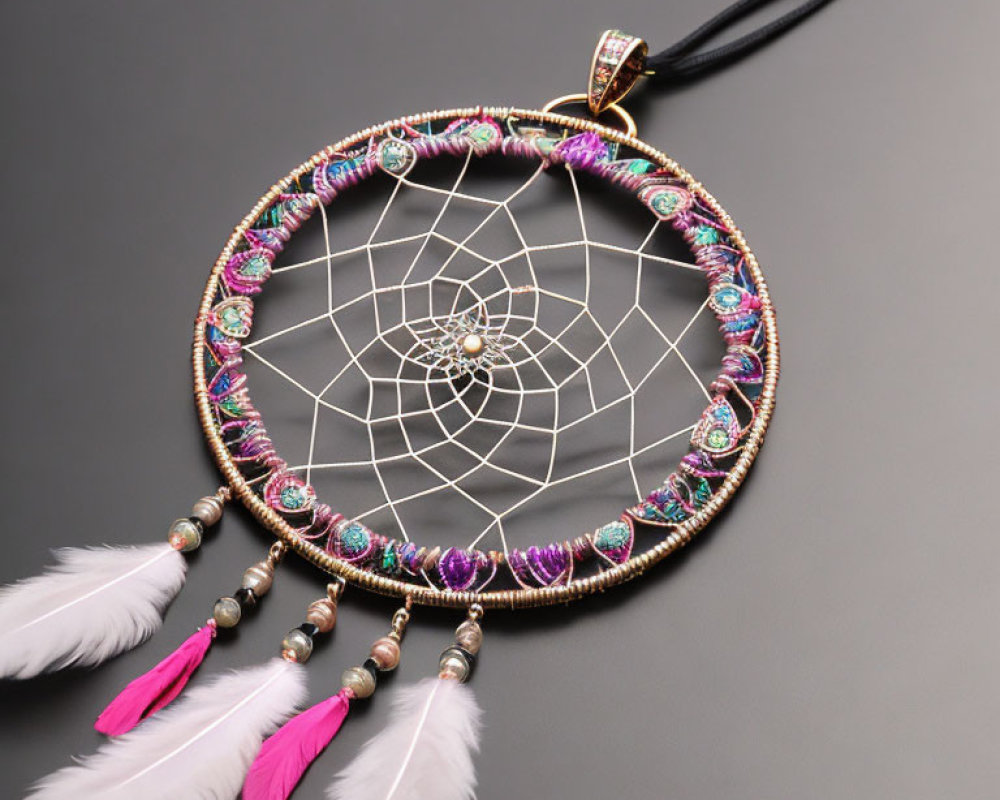 Colorful Dreamcatcher with Beads and Feathers on Grey Background