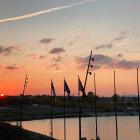 Harbor sunset with ship silhouettes and vibrant sky reflected on water