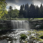 Scenic landscape with cascading waterfall and lush greenery