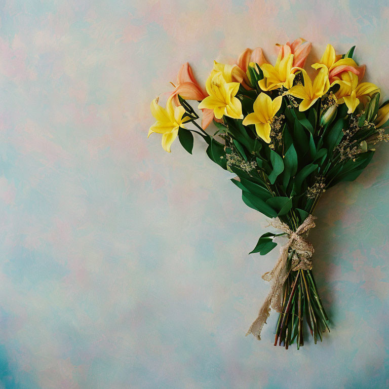 Yellow lilies bouquet on pastel blue background with rustic twine