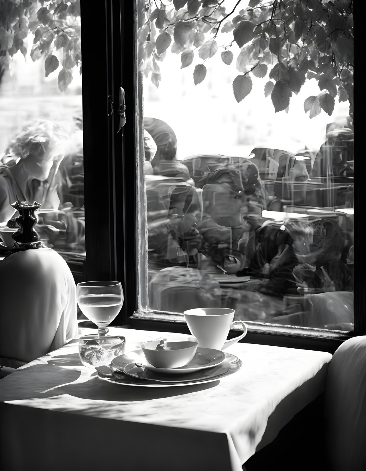 Serene café table with coffee cup and glass of water by window