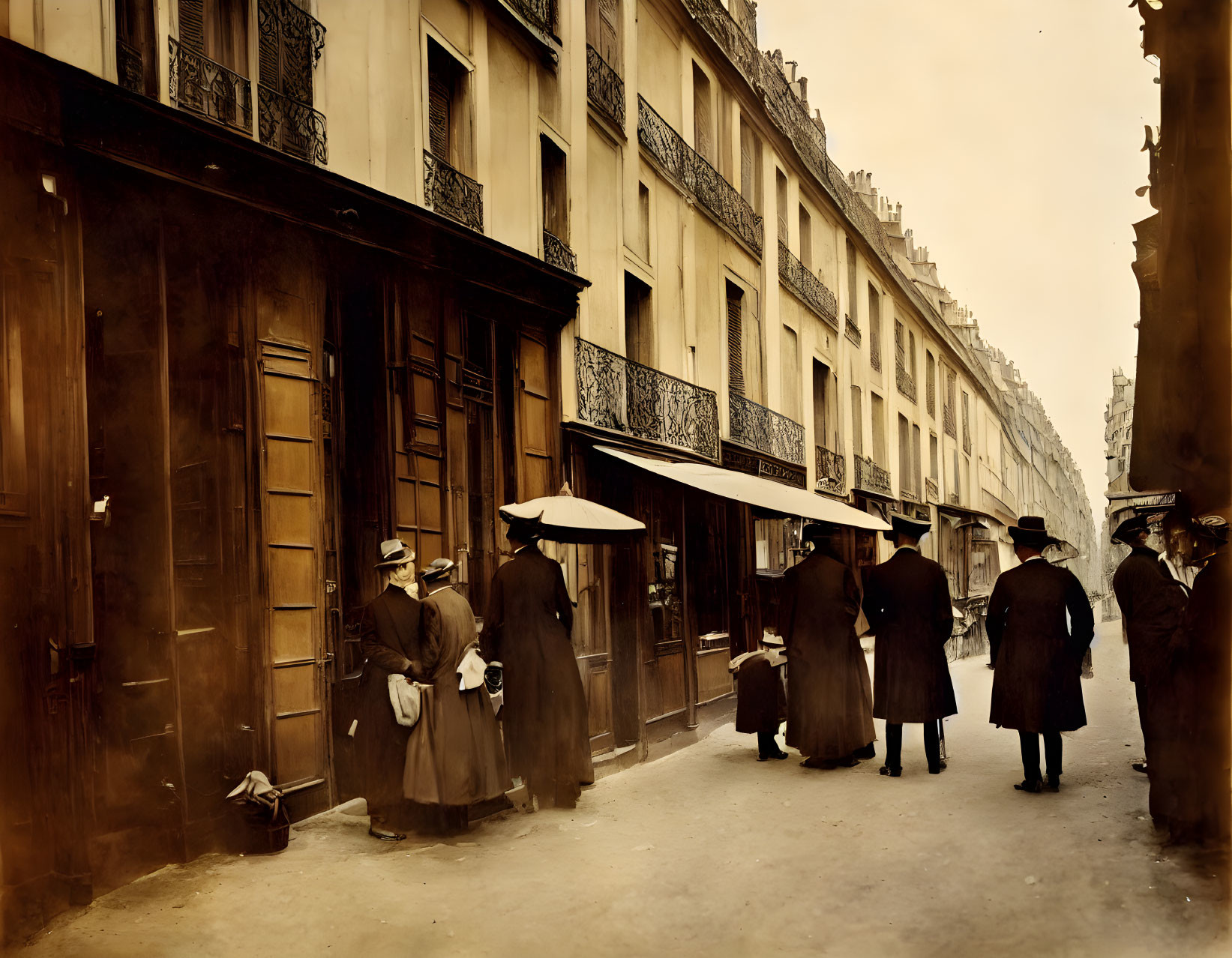 Vintage photo: People in old clothing on city street with classic architecture