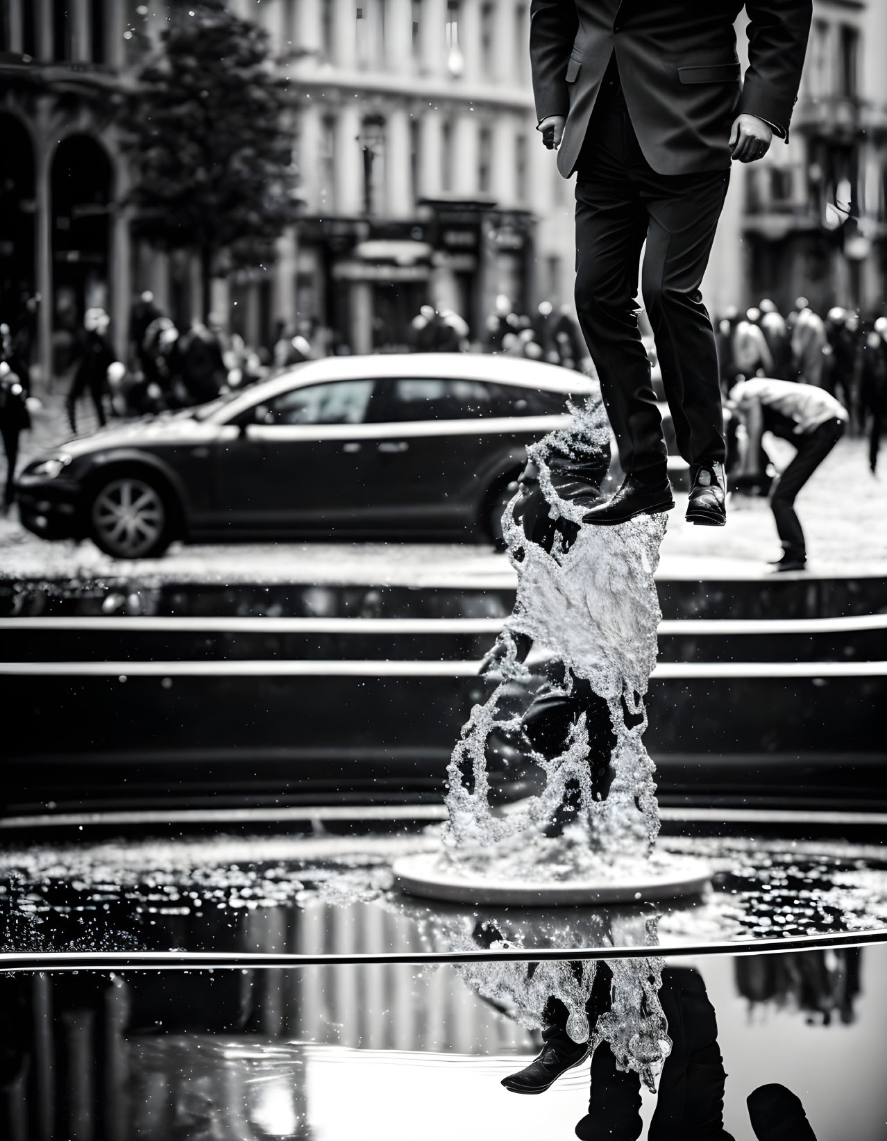 Person's Legs Standing on Water Jet in Street Scene