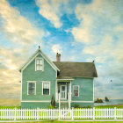 Blue House with White Trim and Picket Fence in Vibrant Garden