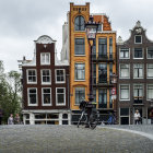 Dutch canal houses, bridges, and flowers under a blue sky