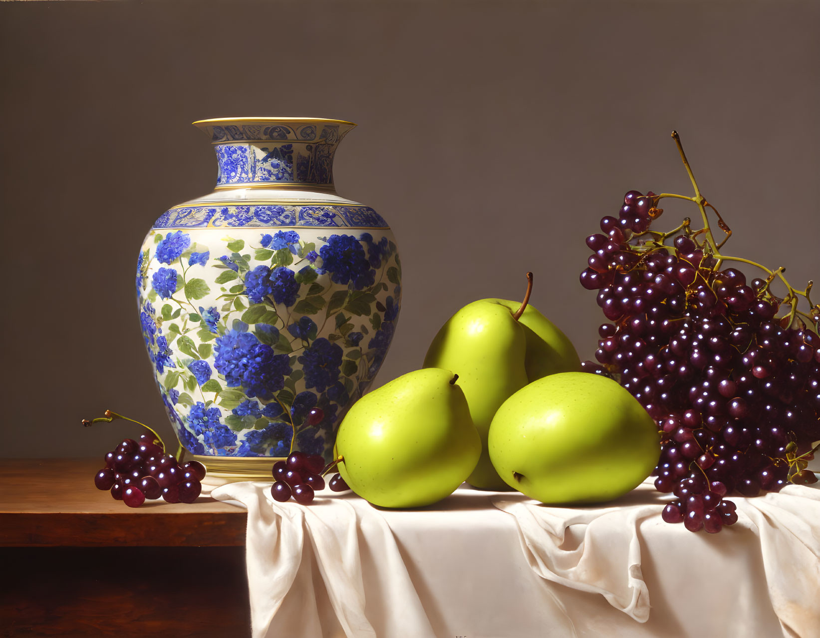 Blue and White Porcelain Vase with Pears and Grapes on White Cloth