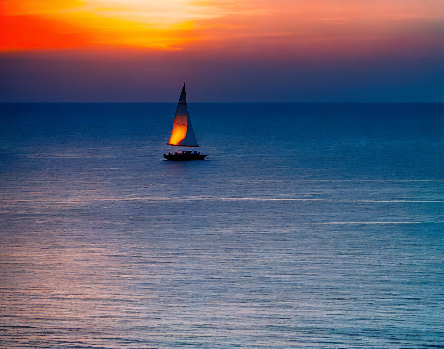 Tranquil sunset scene with sailboat on vibrant orange sea