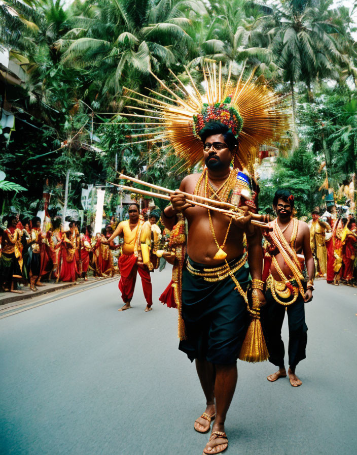 Elaborately dressed man leads traditional procession on tree-lined street