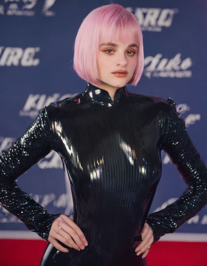 Pink bob haircut woman in black high-neck outfit against logo backdrop