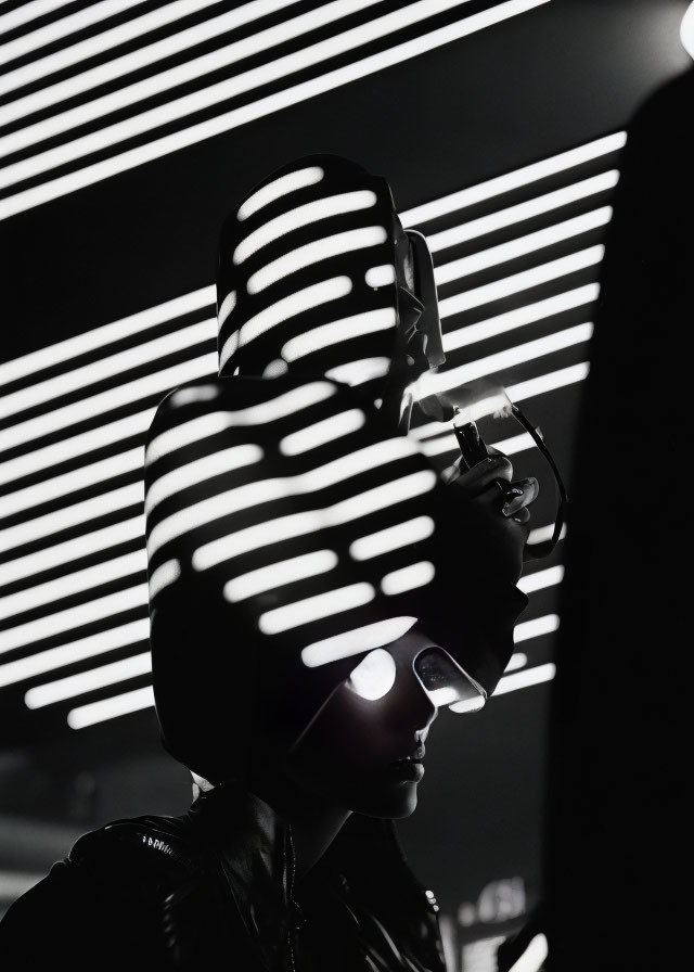 Monochromatic photo of person in leather jacket with white light shadows