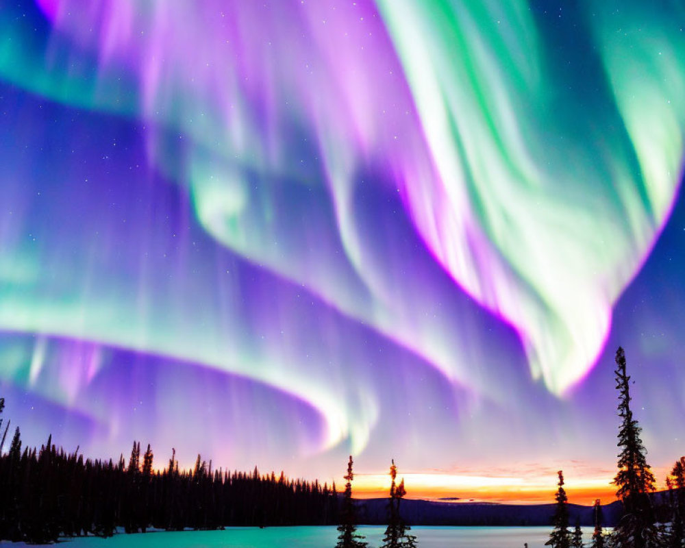 Spectacular purple and green aurora borealis over snowy landscape