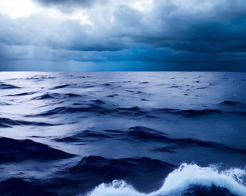 Stormy sky over dark ocean waves with white foam and dramatic cloudscape