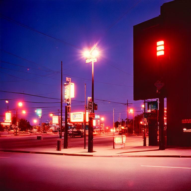 Desolate cityscape with illuminated streetlights and signage at night