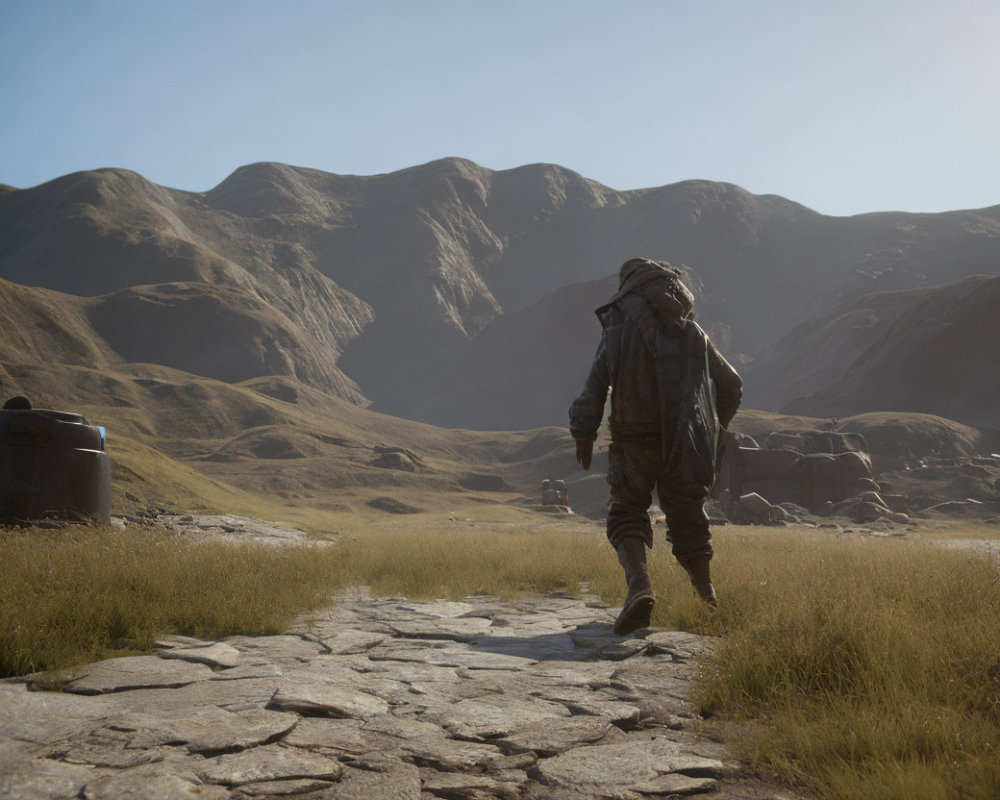 Hiker with large backpack on stone path in mountainous desert landscape