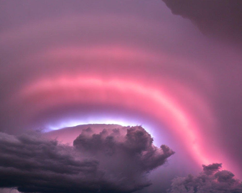 Dramatic sky with pink-tinged eye-shaped cloud in storm