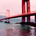 Pink-toned bridge over calm waters with mountains in the backdrop