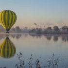 Tranquil lake scene with hot air balloons at sunrise or sunset