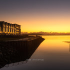 Twilight scene: harbor, silhouetted ships, hillside house, small boats, gradient