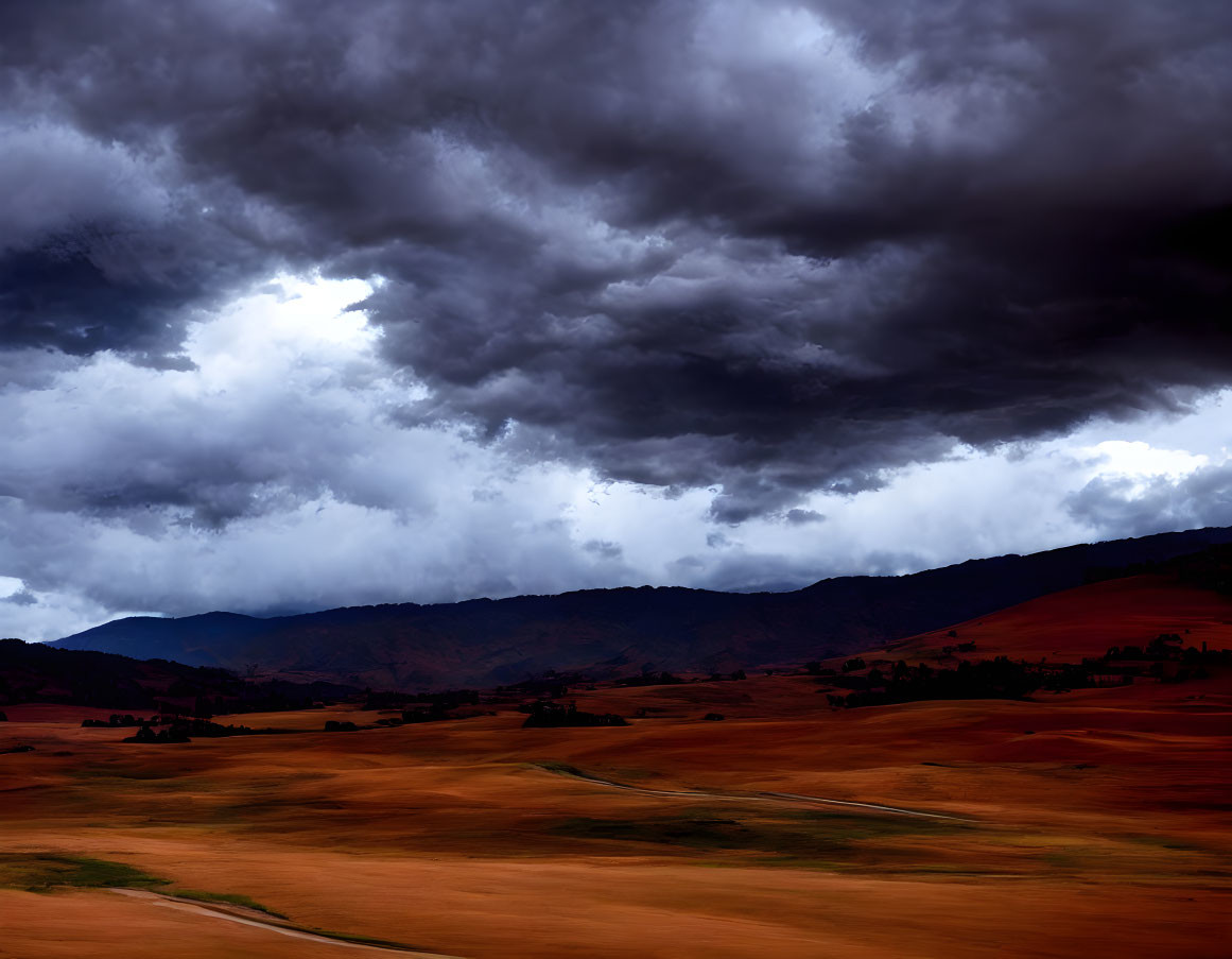 Dramatic landscape with storm clouds over rolling hills