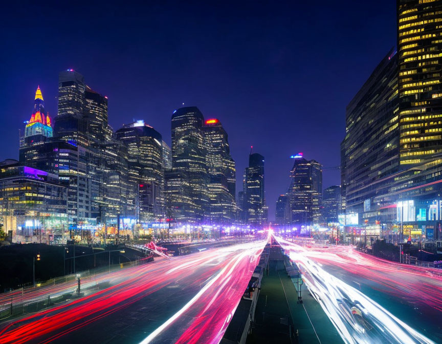 Vibrant night cityscape with illuminated skyscrapers and streaks of light from traffic