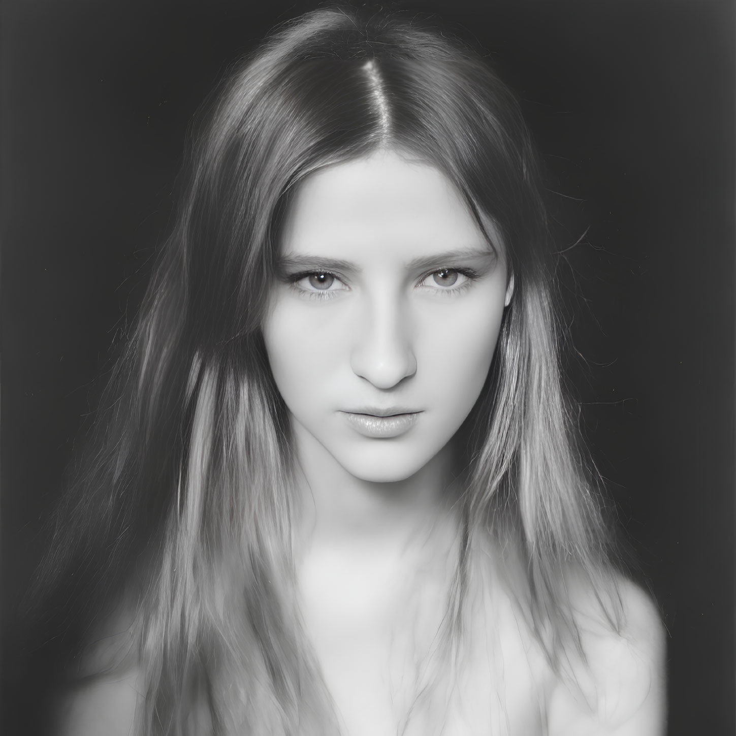 Monochrome portrait of woman with long hair and intense gaze