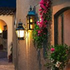 Twilight scene: Street lamps and foliage on cobblestone alley