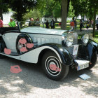 Vintage two-tone car with whitewall tires and chrome accents in nature setting