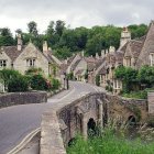 Enchanting fairytale landscape with castles, bridge, pond, greenery, and flowers