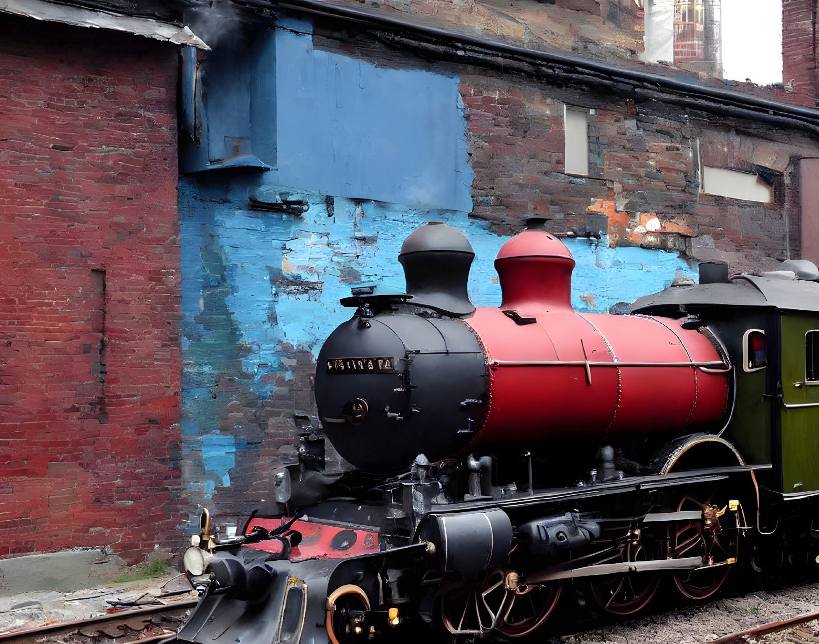 Vintage Red Steam Locomotive Number 1054 Parked Beside Peeling Blue Building