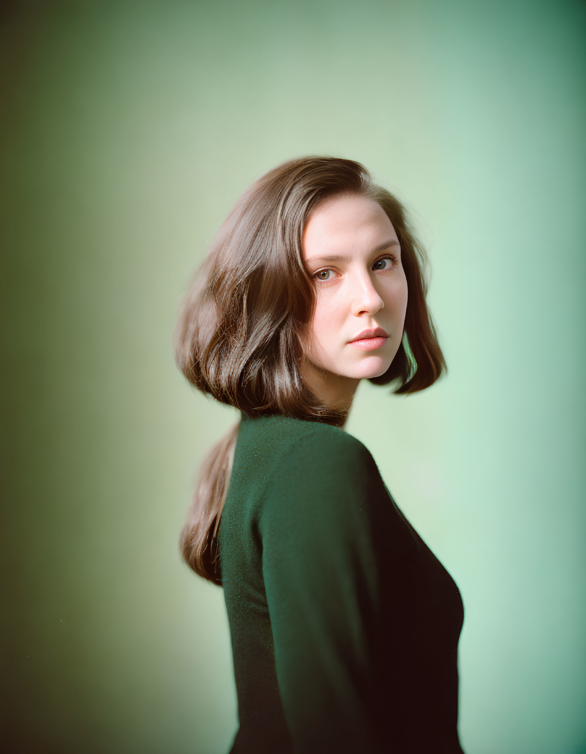 Woman with Long Brown Hair Portrait on Green Background