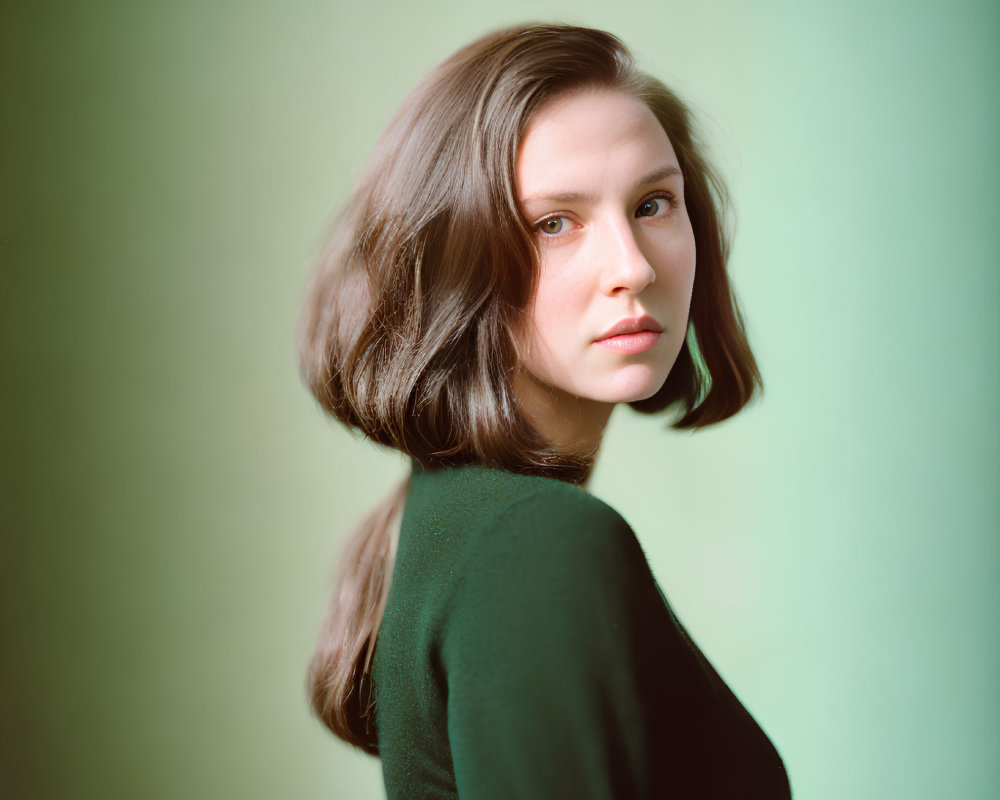 Woman with Long Brown Hair Portrait on Green Background