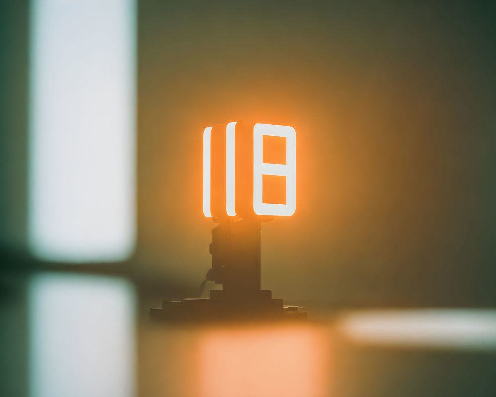 Glowing neon pause symbol sign on pedestal with soft focus background