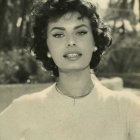 Smiling woman with curly hair in vintage black and white photo