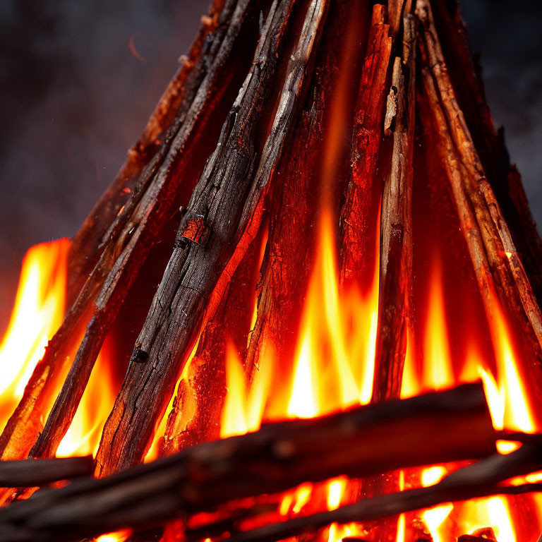 Intense flames engulf stacked wood in close-up view