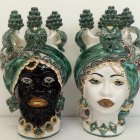 Ornate mannequin heads with leafy headdresses and golden jewelry