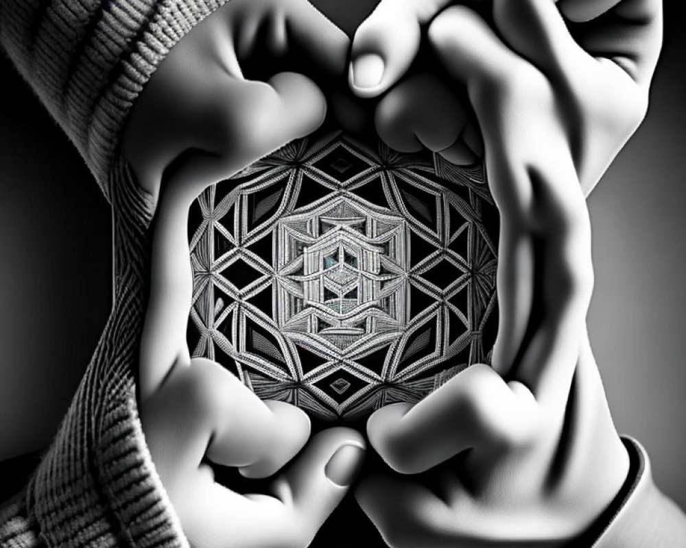 Hands forming heart shape around mandala pattern in black and white.