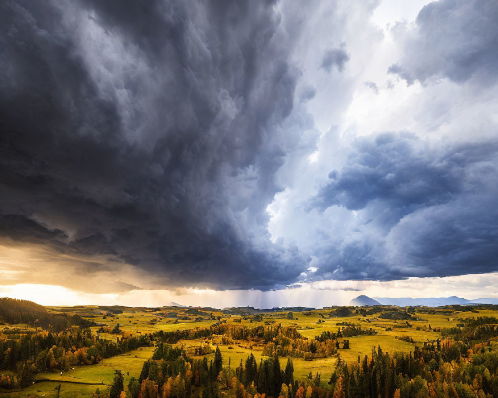 Golden landscape under dramatic storm clouds with sunlight piercing through